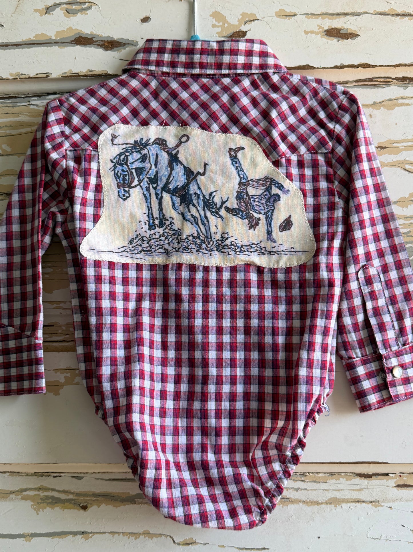 Bucked Off Wrangler Snap Onesie